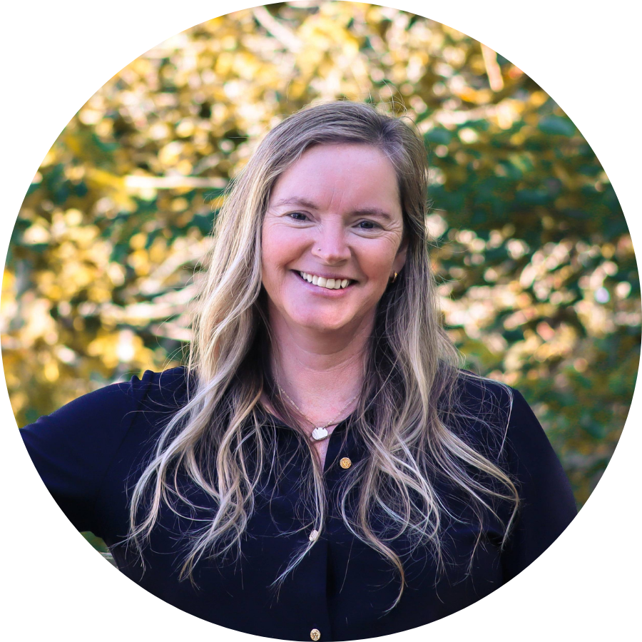 Lindsay Jennings smiling in front of greenery